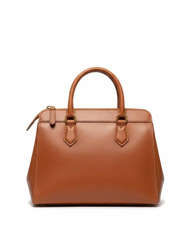 Orange leather shoulder bag on a neutral background