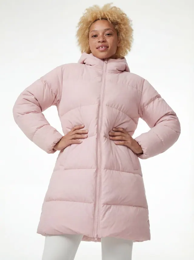 AI-generated model in a pink puffer coat, front view, hands on hips